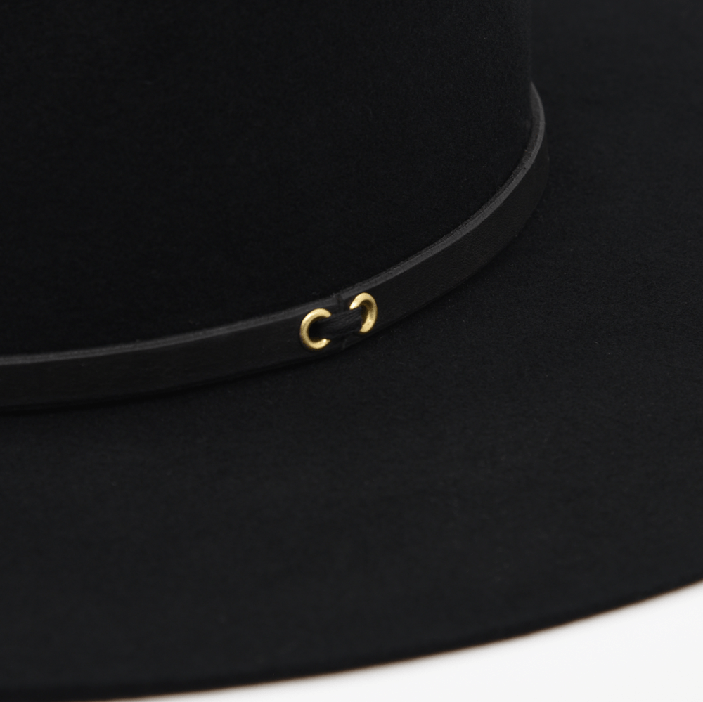 Ninakuru long brim wool hat with black leather band and eyelets. Leather interior band.
