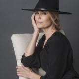 Ninakuru long brim wool hat with black leather band and eyelets. Leather interior band.