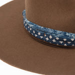 Ninakuru wool hat with cotton wrap band and leather lace.