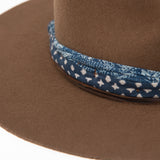 Ninakuru wool hat with cotton wrap band and leather lace.