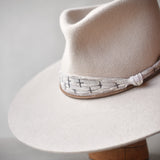 Ninakuru wool hat with cotton wrap band and leather lace.