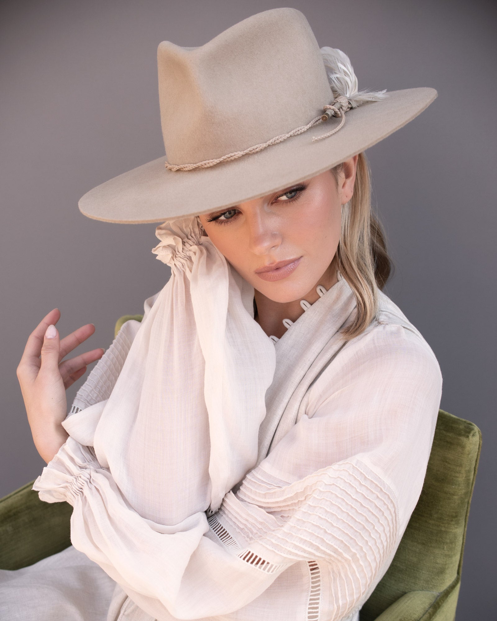 Ninakuru wool hat with braided leather and game feather.