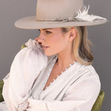 Ninakuru wool hat with braided leather and game feather.