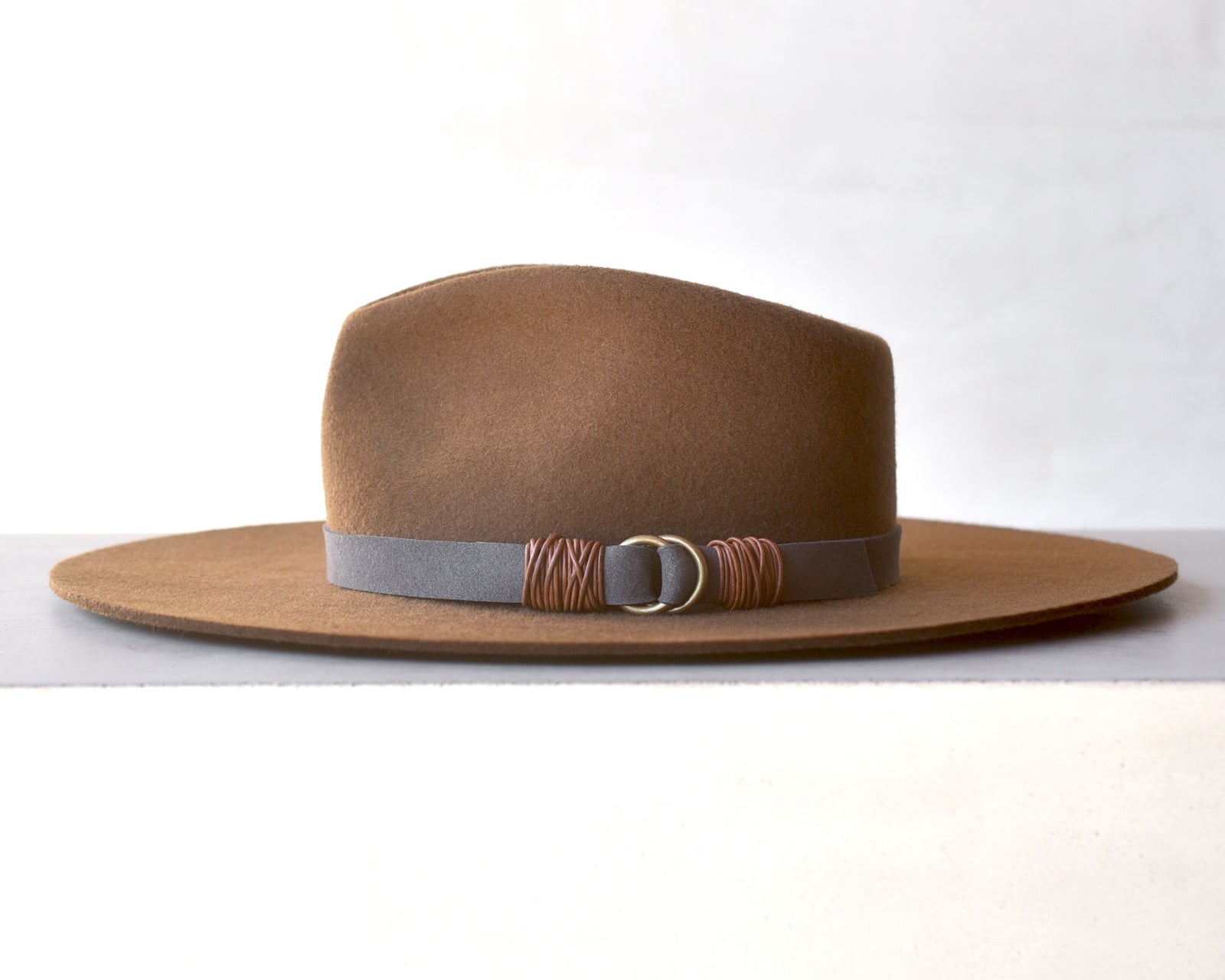 Ninakuru wool hat with vegan band and brass loops.