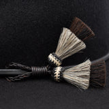 Ninakuru long brim wool hat with leather band and horsehair tassels.