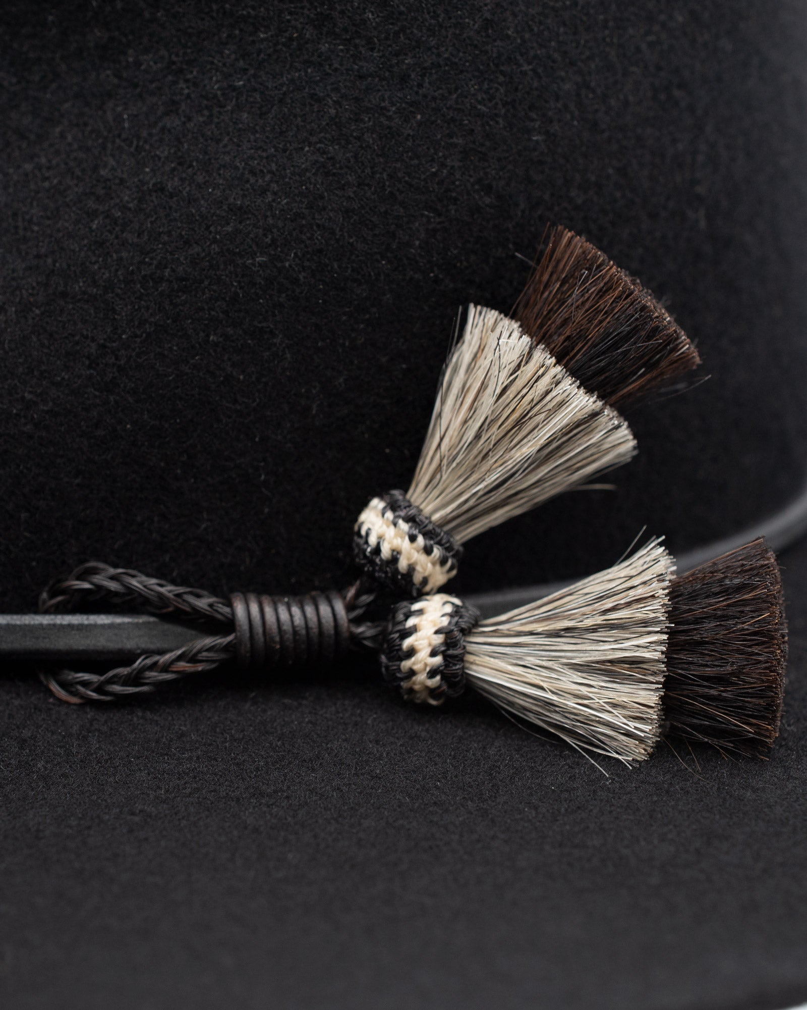 Ninakuru long brim wool hat with leather band and horsehair tassels.