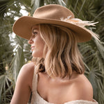 Ninakuru wool hat with game feathers and turquoise.