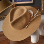 Ninakuru wool hat with game feathers and turquoise.