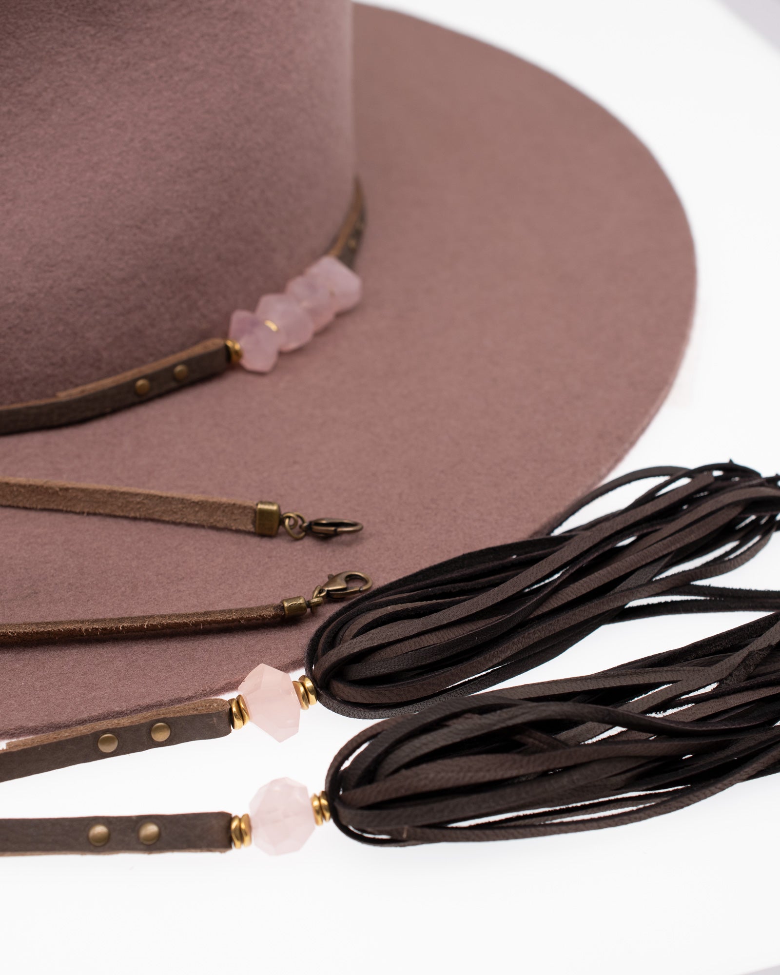 Ninakuru wool felt hat with leather and pink quartz.