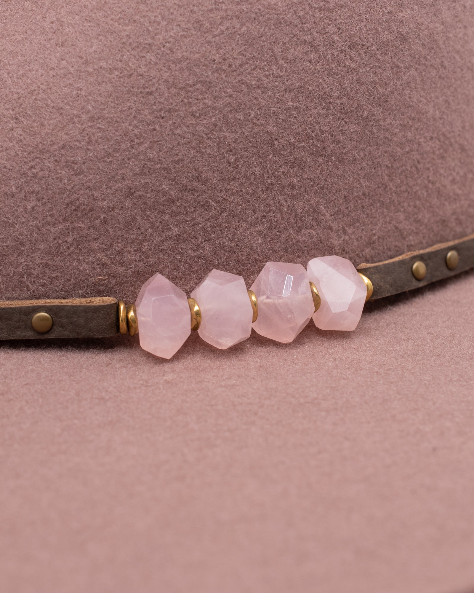 Ninakuru wool felt hat with leather and pink quartz.