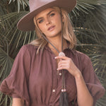 Ninakuru wool felt hat with leather and pink quartz.