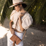 Ninakuru long brim Panama hat with leather band and buckle.
