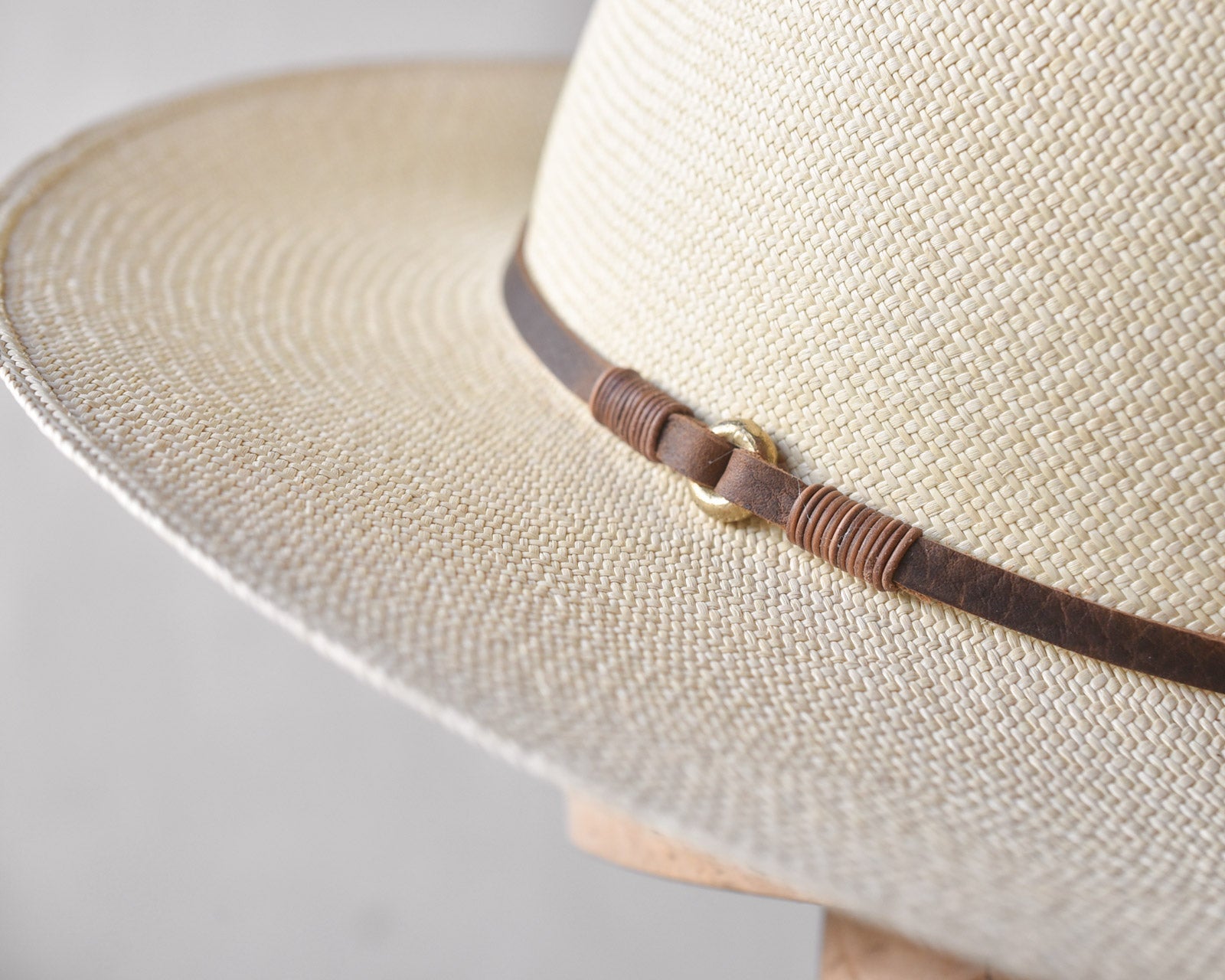 Ninakuru long brim Panama hat with leather lace band and bronze loop.