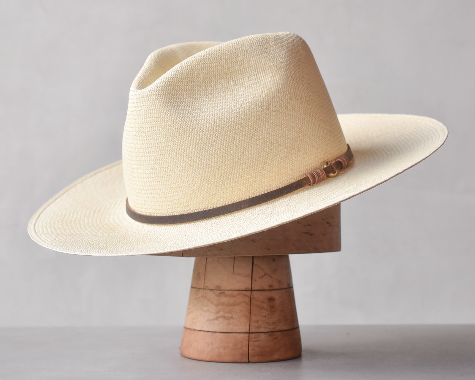 Ninakuru long brim Panama hat with leather lace band and bronze loop.