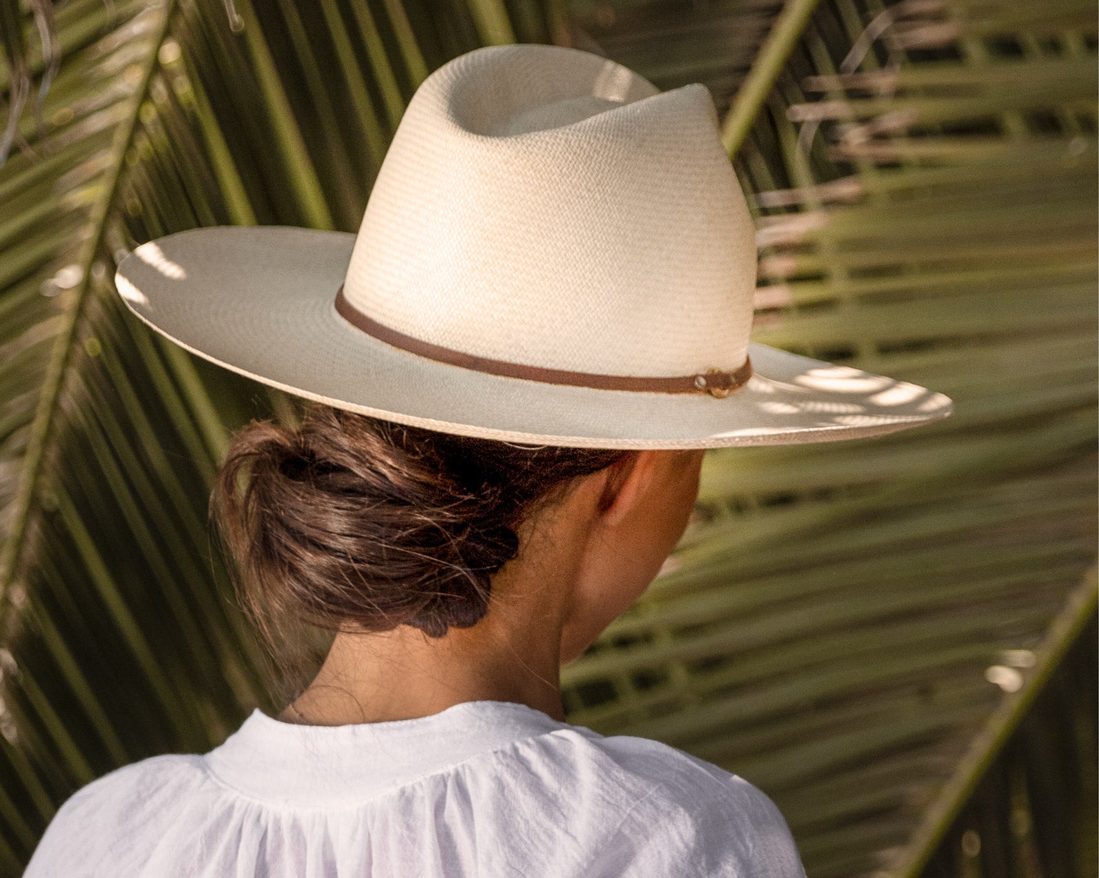 Ninakuru long brim Panama hat with leather lace band and bronze loop.