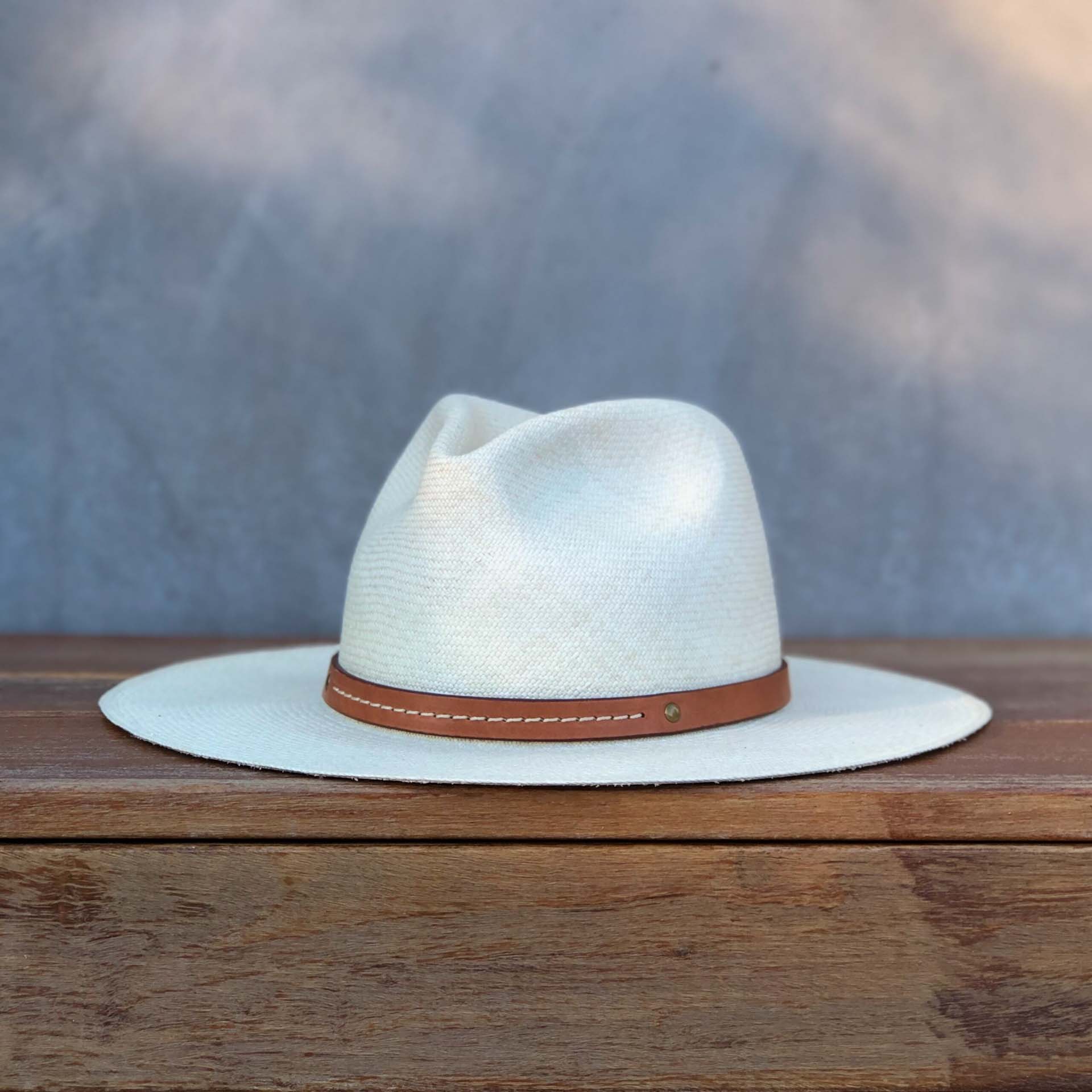 Ninakuru long brim Panama hat with tan leather embellished band, line stitch. Cotton interior band.