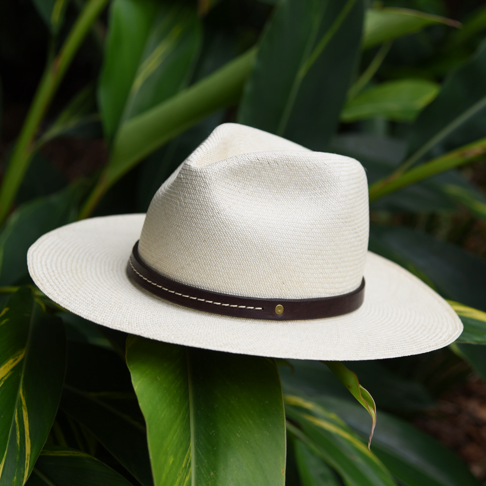 Ninakuru long brim Panama hat with dark brown leather embellished band, line stitch. Cotton interior band.
