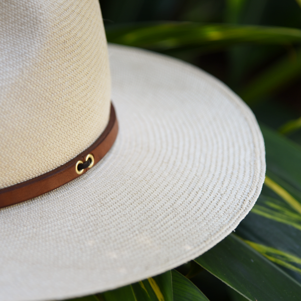 Ninakuru long brim Panama hat with tan leather band and brass eyelets. Cotton interior band.