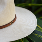 Ninakuru long brim Panama hat with tan leather band and brass eyelets. Cotton interior band.