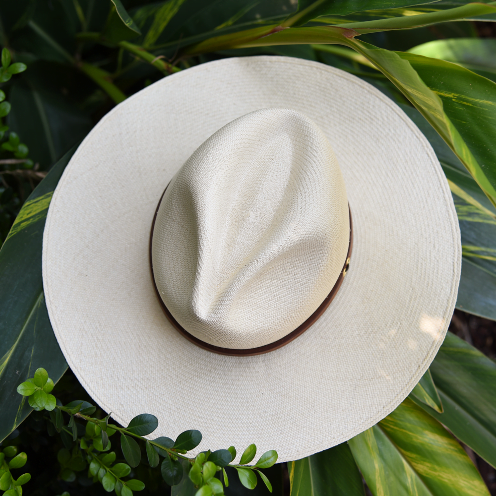 Ninakuru long brim Panama hat with tan leather band and brass eyelets. Cotton interior band.
