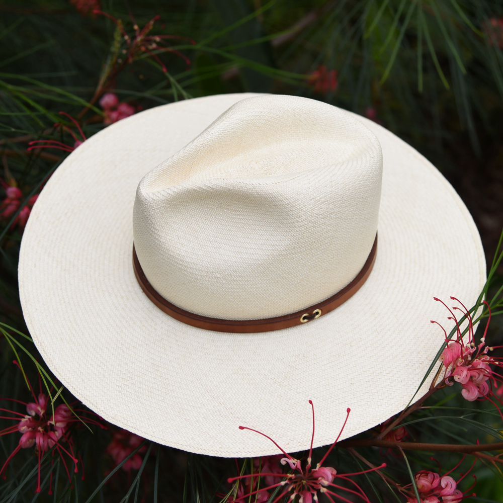Ninakuru long brim Panama hat with tan leather band and brass eyelets. Cotton interior band.