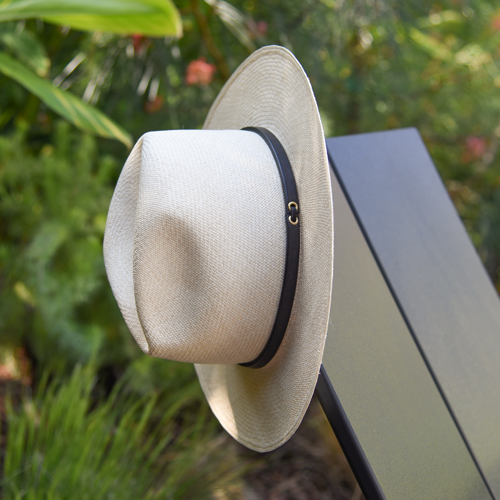 Ninakuru long brim Panama hat with tan leather band and brass eyelets. Cotton interior band.