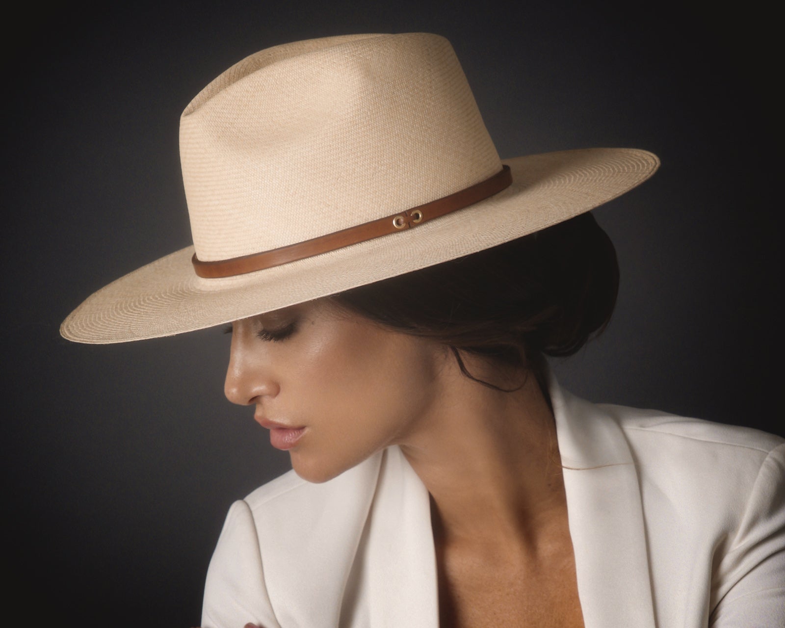 Ninakuru long brim Panama hat with leather band and brass eyelets.