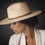 Ninakuru long brim Panama hat with leather band and brass eyelets.