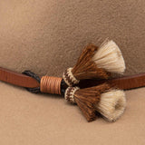 Ninakuru long brim wool hat with leather band and horsehair tassels.