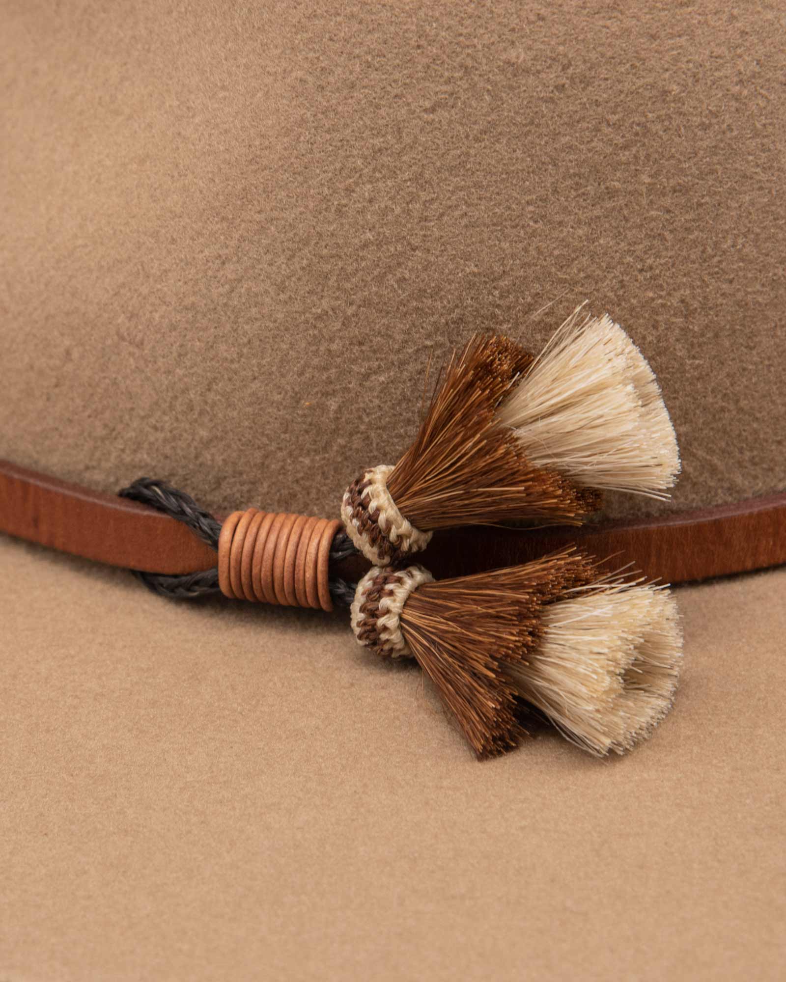 Ninakuru long brim wool hat with leather band and horsehair tassels.