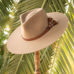 Ninakuru long brim wool hat with leather band and horsehair tassels.