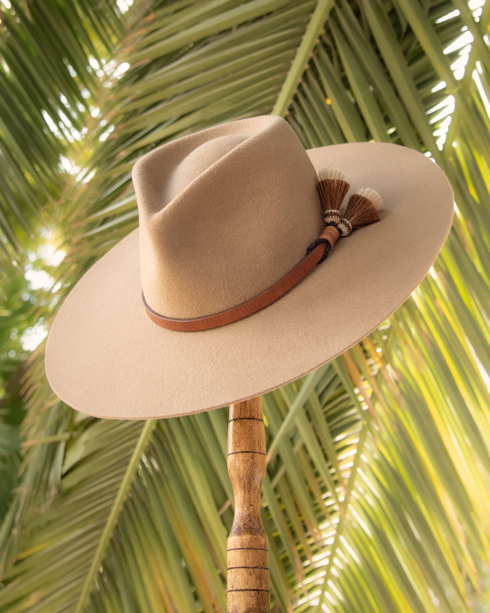 Ninakuru long brim wool hat with leather band and horsehair tassels.