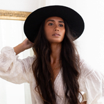 Ninakuru long brim wool hat with black leather band and eyelets. Leather interior band.