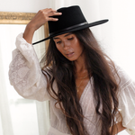 Ninakuru long brim wool hat with black leather band and eyelets. Leather interior band.