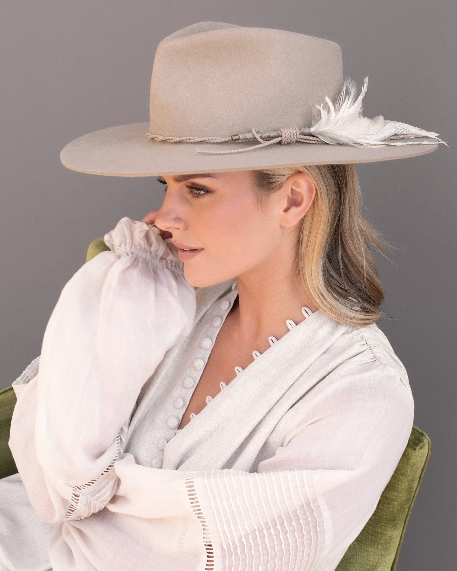 Ninakuru wool hat with braided leather and game feather.