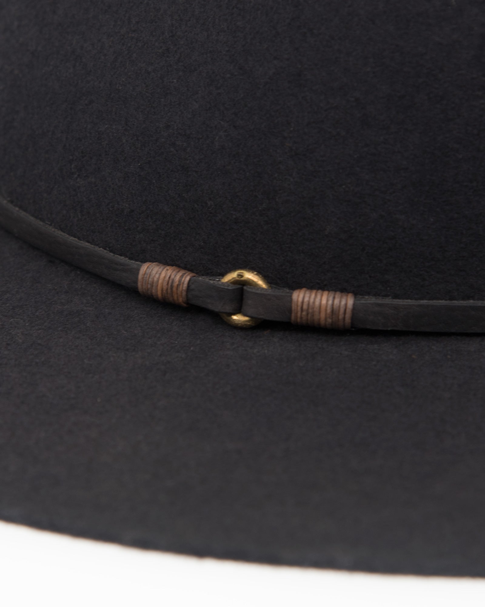 Ninakuru long brim wool hat with leather band and bronze eyelet.
