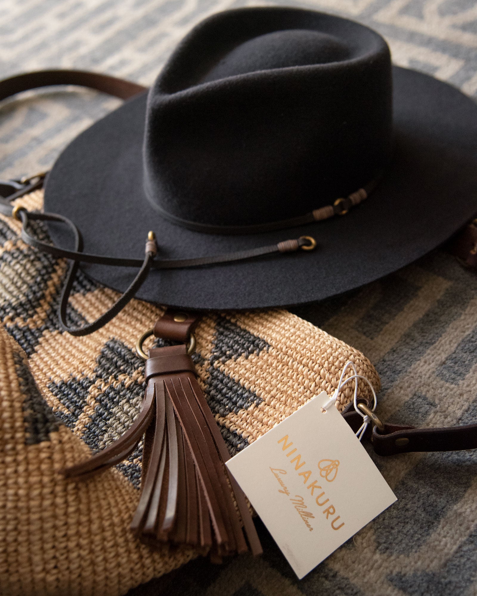 Ninakuru long brim wool hat with leather band and bronze eyelet.