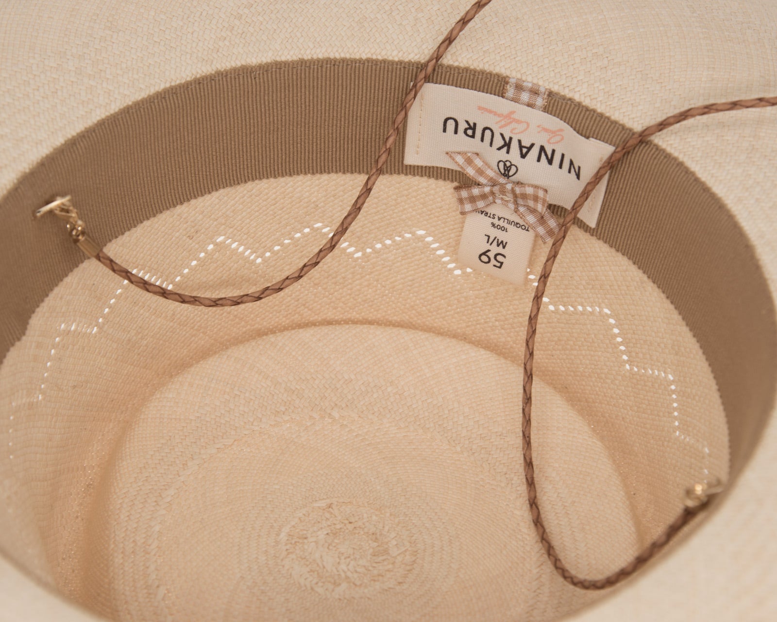 Ninakuru Panama hat with leather braided band and stampede strap.