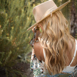 Ninakuru wool hat with leather and feather.