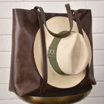 Leather tote bag with hat carrier.