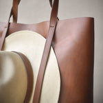 Leather tote bag with hat carrier.