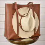 Leather tote bag with hat carrier.