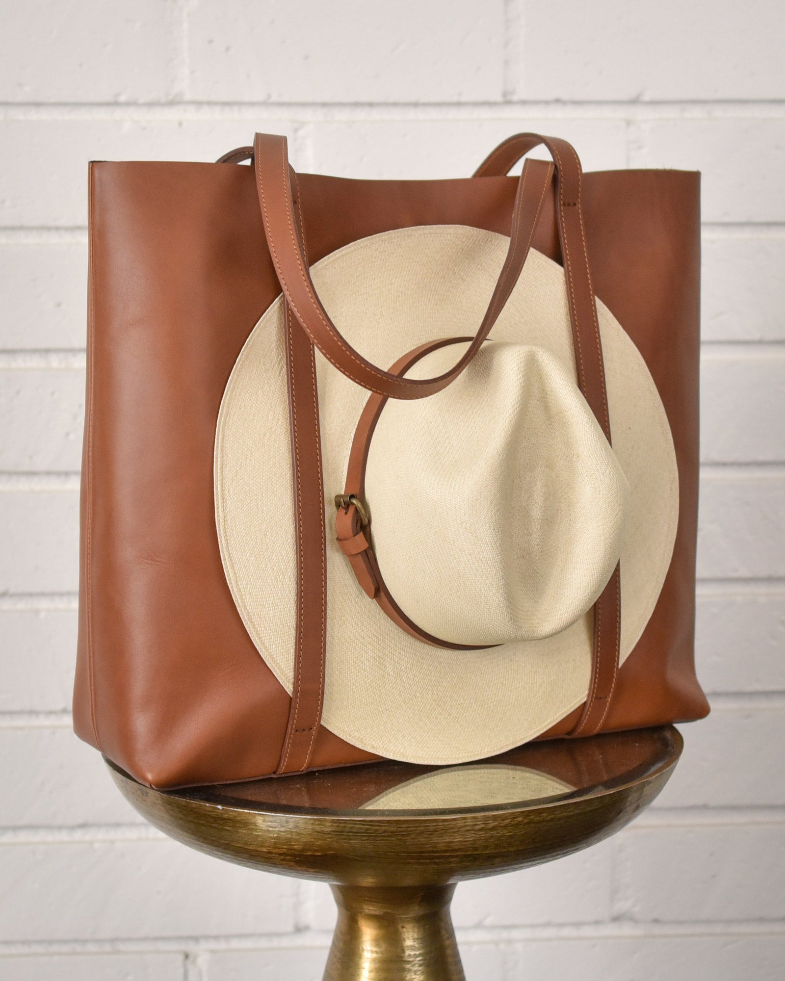Leather tote bag with hat carrier.