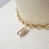 Ninakuru Panama straw hat with gold tone chain and seashells.