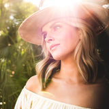 Woman wearing a Ninakuru dyed Panama hat with vegan band.